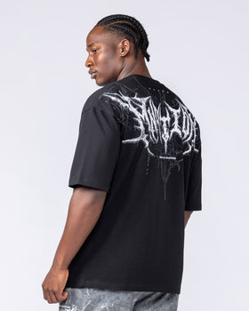 Male model over-shoulder view of the black Gothic Tee with MNation gothic back graphic