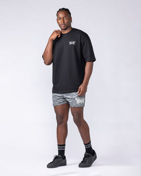 Black Gothic Oversized Tee styled with matching gothic print shorts on a male model, full outfit