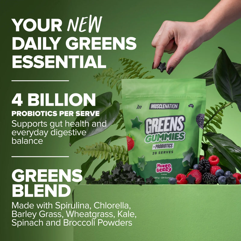 A hand taking a Greens Gummy from the pouch among berries and leaves
