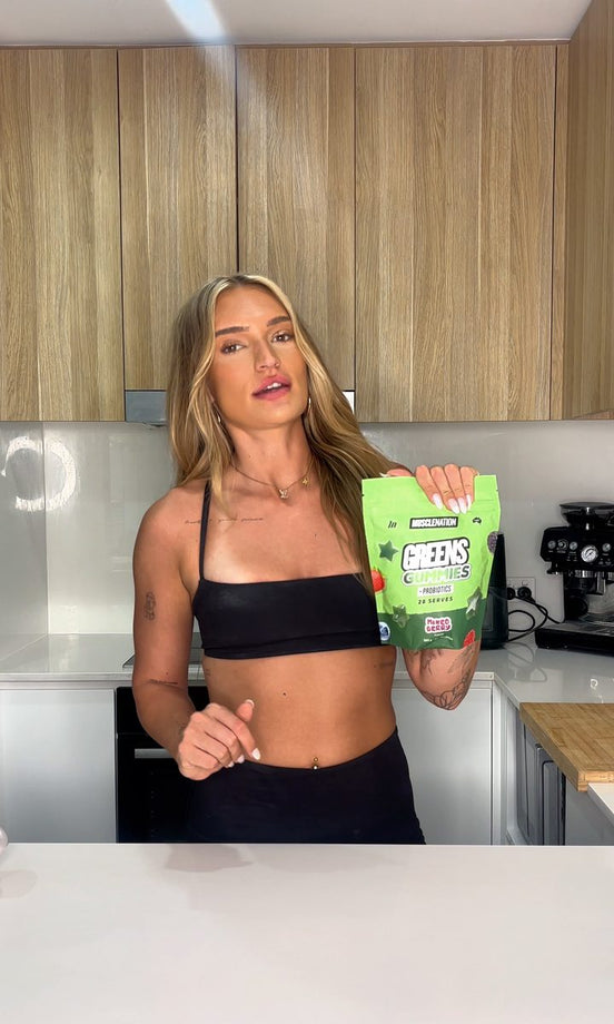 Jaymee Dixon holding a pouch of Greens Gummies