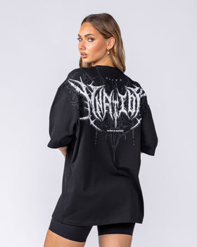 Woman wearing the black Gothic Oversized Tee, back view of the MNation gothic graphic